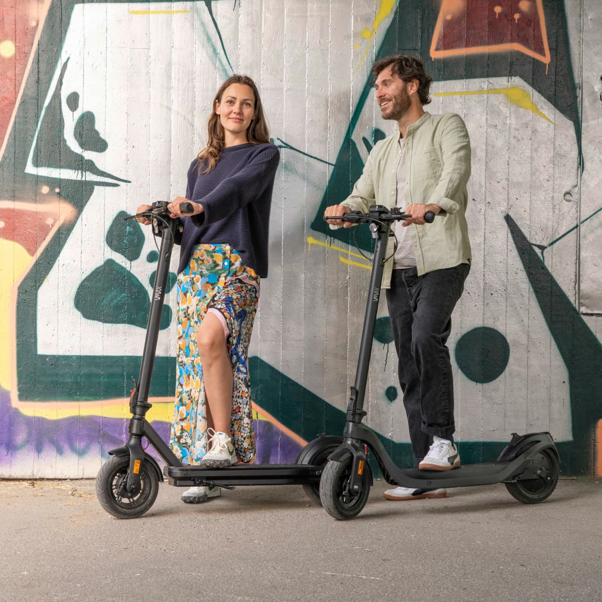 Person with Vmax e-scooter by the river